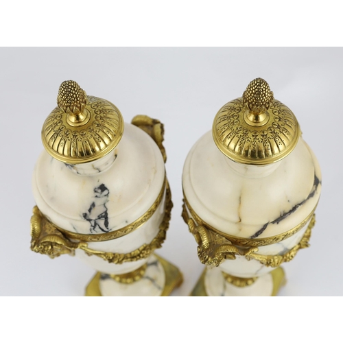 84 - A pair of Italian ormolu mounted calacaita marble urns, with fruiting finials and ram's head and swa... 