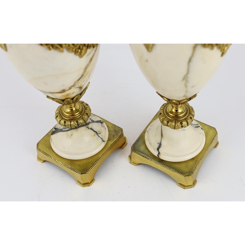 84 - A pair of Italian ormolu mounted calacaita marble urns, with fruiting finials and ram's head and swa... 