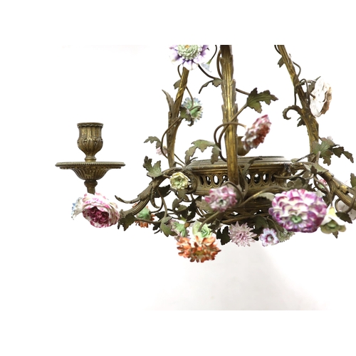 88 - * * A Louis XVI style ormolu and porcelain three light chandelier with scrollwork frame, three reede... 