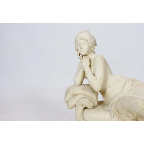 90 - An early 20th century French carved white marble figure of a semi-clad woman seated upon a daybed, r... 