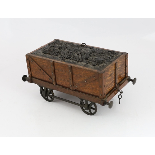 95 - An Edwardian novelty oak smoker's compendium modelled as a railway tender, with simulated coal locka... 