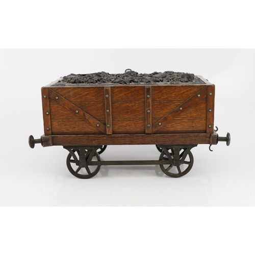 95 - An Edwardian novelty oak smoker's compendium modelled as a railway tender, with simulated coal locka... 