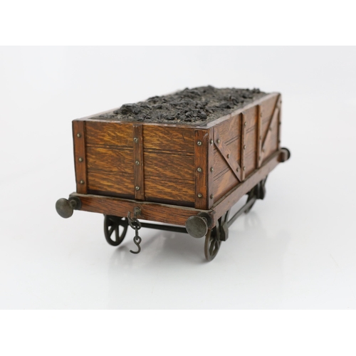 95 - An Edwardian novelty oak smoker's compendium modelled as a railway tender, with simulated coal locka... 