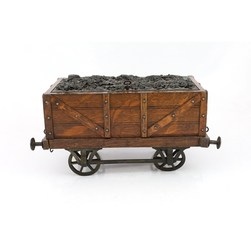 95 - An Edwardian novelty oak smoker's compendium modelled as a railway tender, with simulated coal locka... 