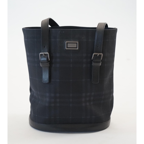 1004 - A Burberry bucket bag in blue black tartan canvas and leather, pewter coloured metalware, with dust ... 