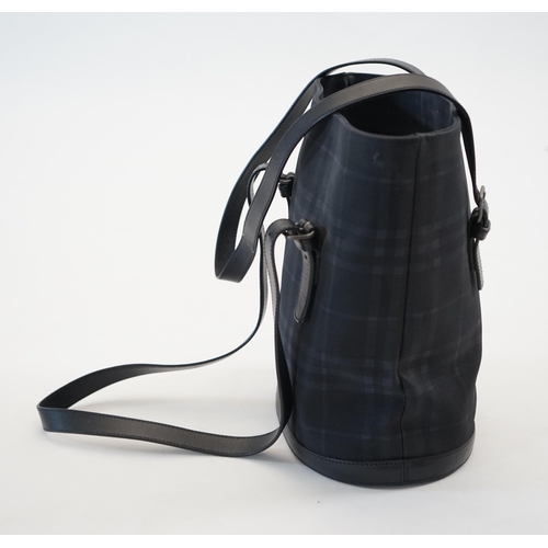 1004 - A Burberry bucket bag in blue black tartan canvas and leather, pewter coloured metalware, with dust ... 