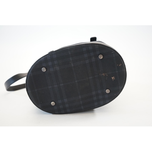 1004 - A Burberry bucket bag in blue black tartan canvas and leather, pewter coloured metalware, with dust ... 