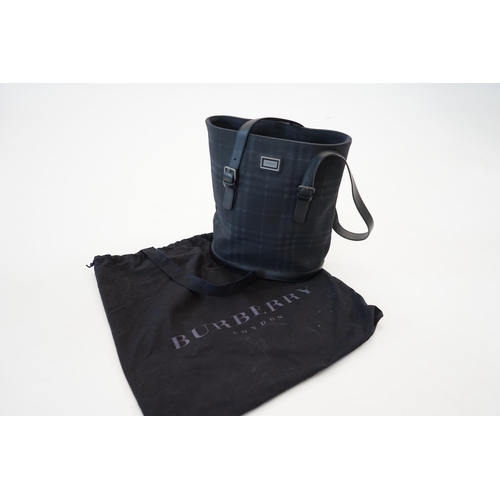 1004 - A Burberry bucket bag in blue black tartan canvas and leather, pewter coloured metalware, with dust ... 