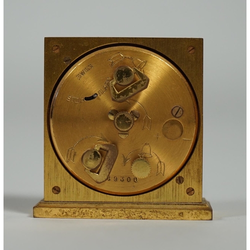 1012 - A Hermès travel alarm clock in gilded brass chiselled with H enchassés, in original leather case, di... 