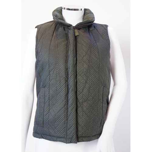 1022 - A Prada quilted olive green and brown lady's gilet with hood in collar, size M