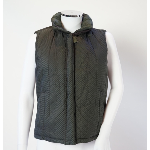 1022 - A Prada quilted olive green and brown lady's gilet with hood in collar, size M