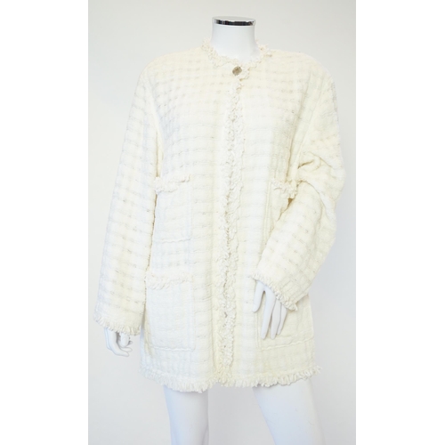 1026 - A Chanel early 1990's cream boutique jacket, with fringing to all edges, single CC silver-tone butto... 