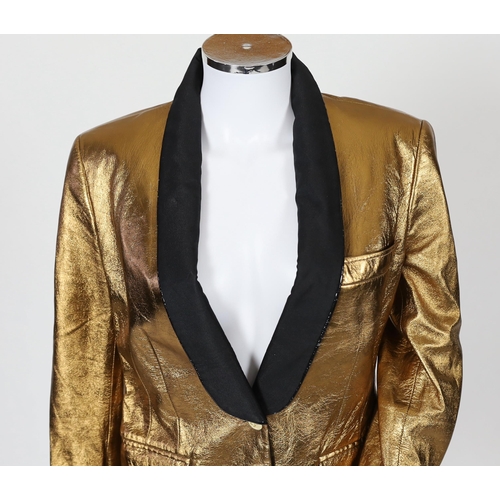 1030 - A lady's Dolce & Gabbana gold metallic leather jacket, with black lapels and leopard print lining, s... 