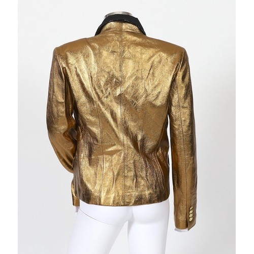 1030 - A lady's Dolce & Gabbana gold metallic leather jacket, with black lapels and leopard print lining, s... 