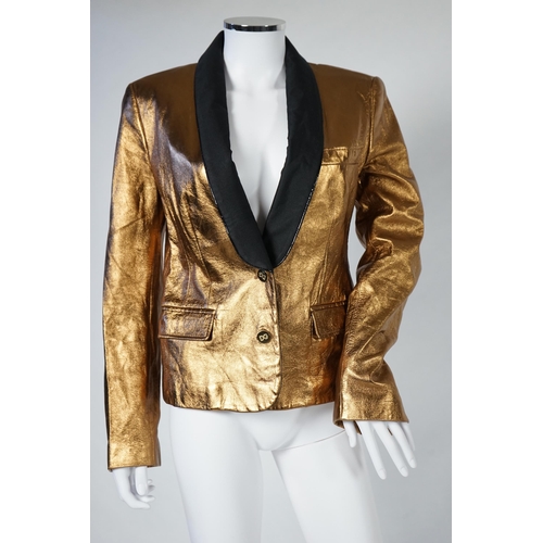 1030 - A lady's Dolce & Gabbana gold metallic leather jacket, with black lapels and leopard print lining, s... 