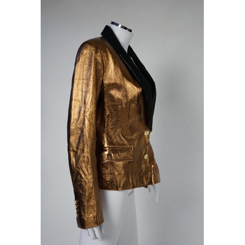 1030 - A lady's Dolce & Gabbana gold metallic leather jacket, with black lapels and leopard print lining, s... 