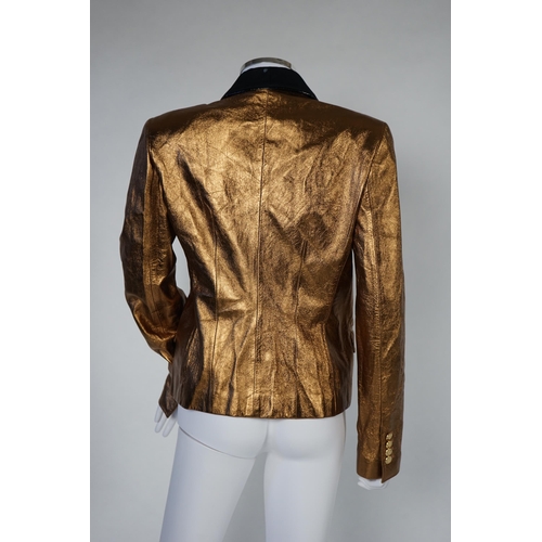 1030 - A lady's Dolce & Gabbana gold metallic leather jacket, with black lapels and leopard print lining, s... 