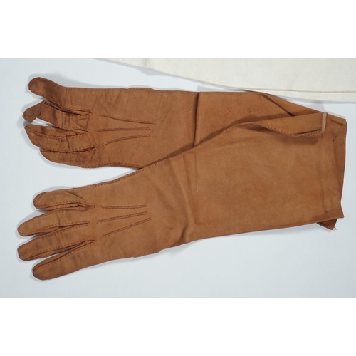 1038 - A pair of lady's Hermès skin gloves, boxed and three other pairs of gloves