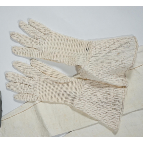 1038 - A pair of lady's Hermès skin gloves, boxed and three other pairs of gloves