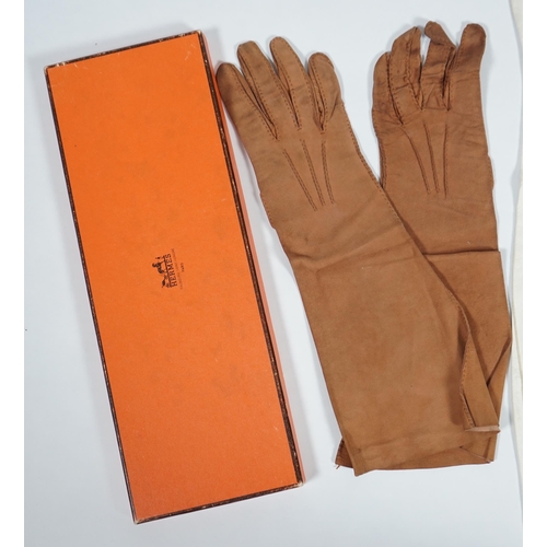 1038 - A pair of lady's Hermès skin gloves, boxed and three other pairs of gloves