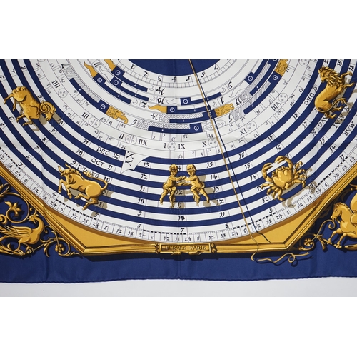 1040 - A Hermès Dies et Hore navy silk scarf, 90cm x 90cm