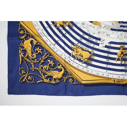 1040 - A Hermès Dies et Hore navy silk scarf, 90cm x 90cm