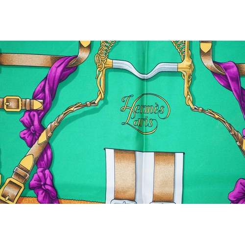 1042 - A Hermès 'Grand Manège' Henry d'Origny silk scarf, purples, golds, green, turquoise and pink colours... 