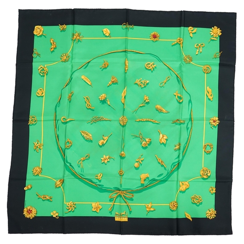 1044 - A Hermès 'Clips' 1986 Vladimir Rybaltchenko silk scarf, in vibrant green and gold with navy blue bor... 