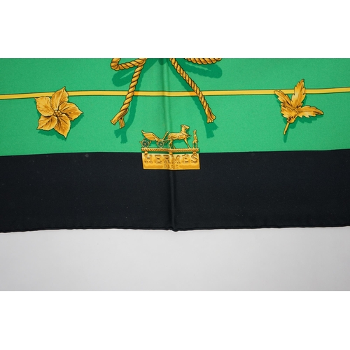 1044 - A Hermès 'Clips' 1986 Vladimir Rybaltchenko silk scarf, in vibrant green and gold with navy blue bor... 