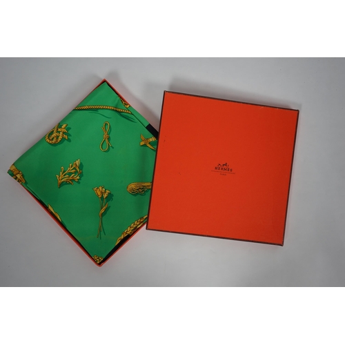 1044 - A Hermès 'Clips' 1986 Vladimir Rybaltchenko silk scarf, in vibrant green and gold with navy blue bor... 