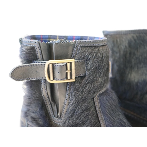 1056 - A pair of Chanel lady's navy blue leather calf hair pleated belted buckle boots, with blue tartan in... 