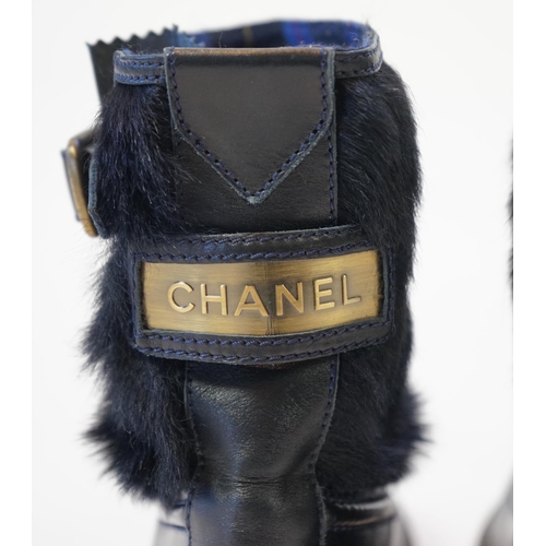 1056 - A pair of Chanel lady's navy blue leather calf hair pleated belted buckle boots, with blue tartan in... 