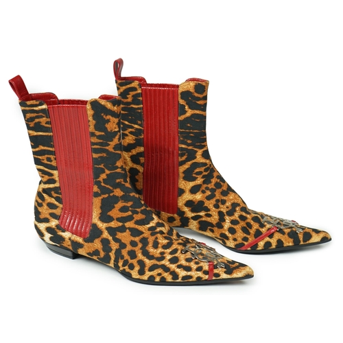 1061 - A pair of Christian Dior, Hardcore Collection, lady's leopard canvas ankle boots, with red leather t... 