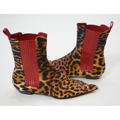 1061 - A pair of Christian Dior, Hardcore Collection, lady's leopard canvas ankle boots, with red leather t... 