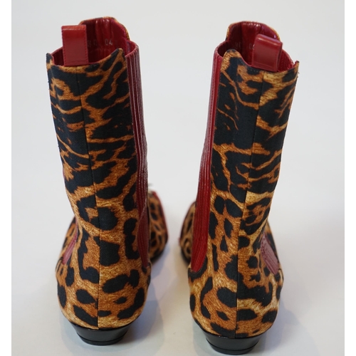 1061 - A pair of Christian Dior, Hardcore Collection, lady's leopard canvas ankle boots, with red leather t... 