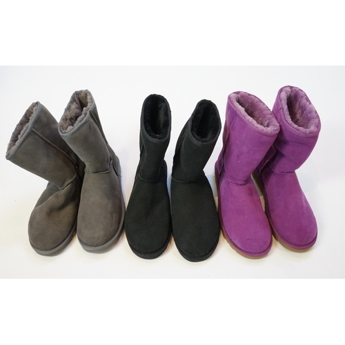 1063 - Three pairs of lady's sheepskin UGG boots, in grey, black and purple, size UK 7.5