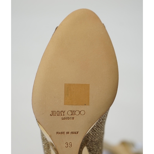 1069 - Two pairs of Jimmy Choo gold lady's heeled shoes, one sandal in gold leather and the other in textur... 