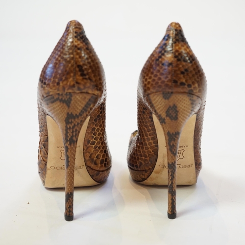 1073 - A pair of Jimmy Choo lady's snakeskin platform pumps in brown and black, 5" heels, with dust ba... 