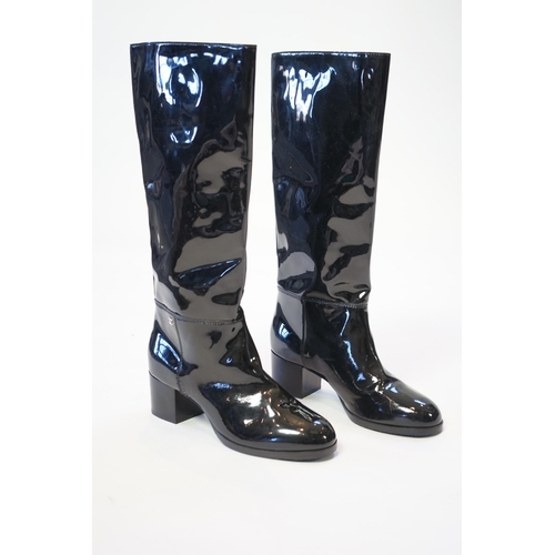 1075 - A pair of Chanel lady's black patent knee high mid heel rain boots, with CC to the outside ankle are... 