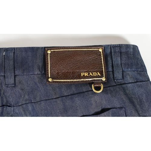 1096 - Three pairs of Prada lady's jeans Prada, black denim with side zips, size 27Prada lightweight blue d... 