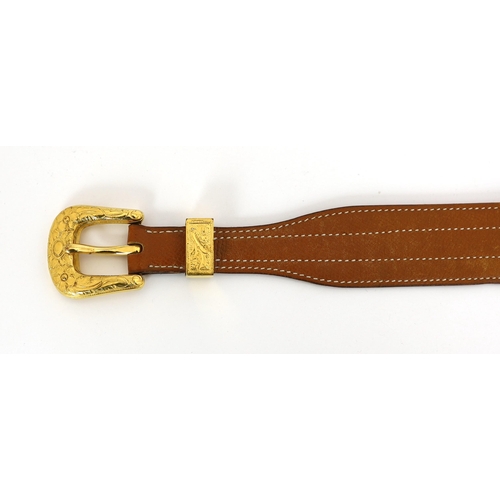 1101 - A Hermès lady's tan leather belt, with gold tone buckle and white stitching, size XS/Small