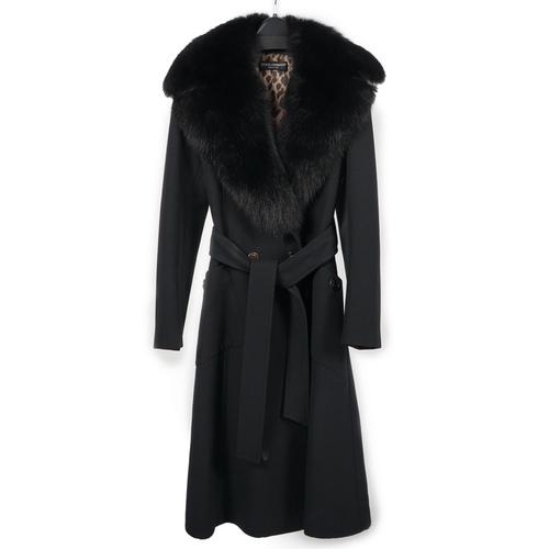 1113 - A Dolce & Gabbana lady's black wool coat with detachable fur collar, leopard print lining and tie be... 