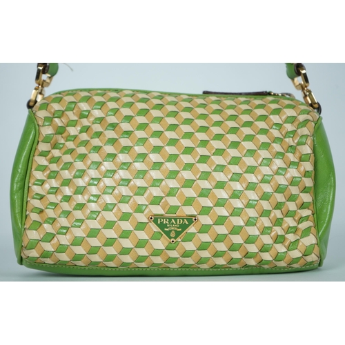 1125 - A Prada green and beige leather Intreccio Cube shoulder bag, zip closure with lock included. Woven c... 