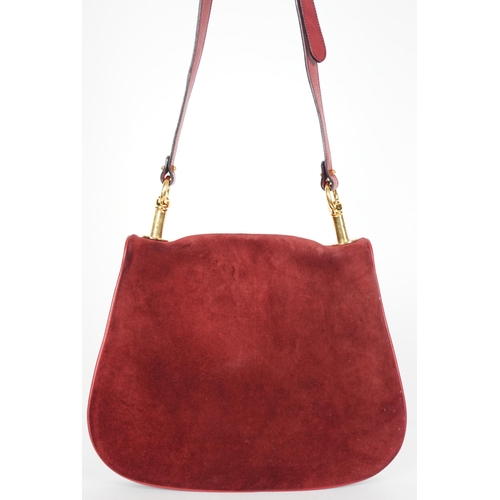 1126 - A vintage Gucci Blondie claret suede shoulder bag, Gucci gold toned intertwined double G logo is fro... 