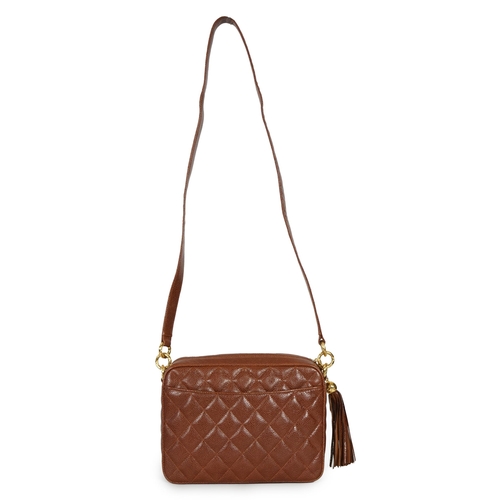 1129 - A Chanel vintage camera bag with tassel in brown quilted calf skin, matching leather shoulder strap,... 