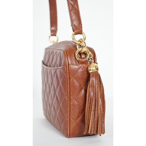 1129 - A Chanel vintage camera bag with tassel in brown quilted calf skin, matching leather shoulder strap,... 