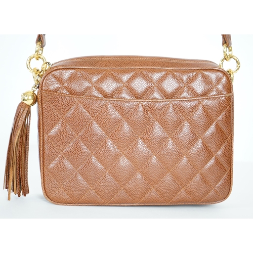 1129 - A Chanel vintage camera bag with tassel in brown quilted calf skin, matching leather shoulder strap,... 