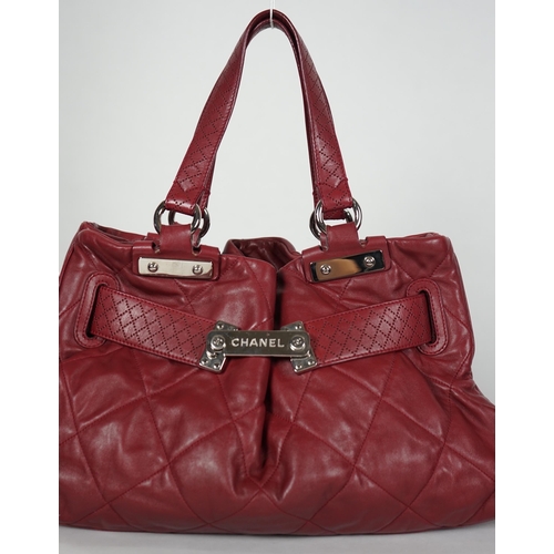 1130 - ** ** A Chanel burgundy leather buckled handle bag, with dust bag, Authentication no: 12244695 (with... 