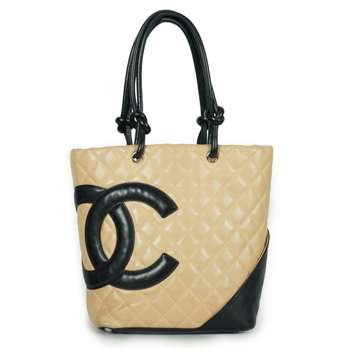 1134 - ** ** A Chanel Cambon Ligne black and beige quilted leather tote, the Cambon Ligne tote features a q... 