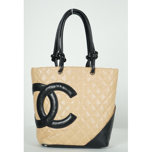 1134 - ** ** A Chanel Cambon Ligne black and beige quilted leather tote, the Cambon Ligne tote features a q... 